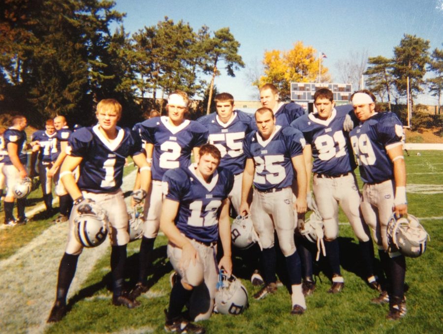 Members of the 2003 TKE pledge class in navy Butler football uniforms, posing on game day at the old Butler Bowl.