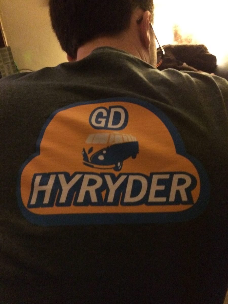 The back of a gray shirt with an orange GD Hyryder logo.
