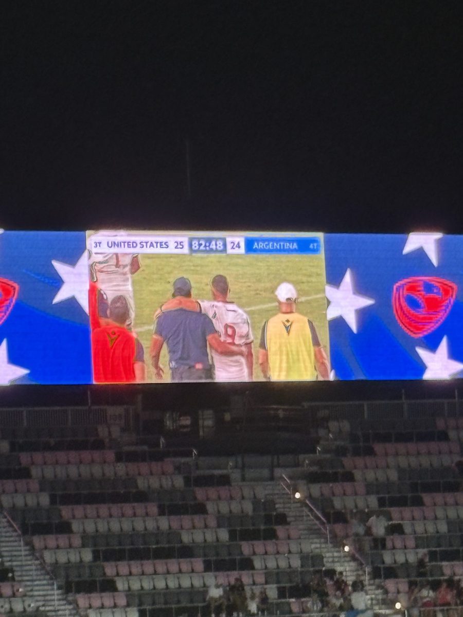 Stadium video board showing USA ahead of Argentina XV during a rugby match.